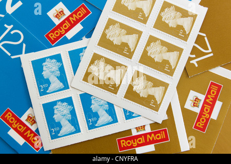 UK, Britain. Royal Mail first and second class postage stamps and stamp books Stock Photo