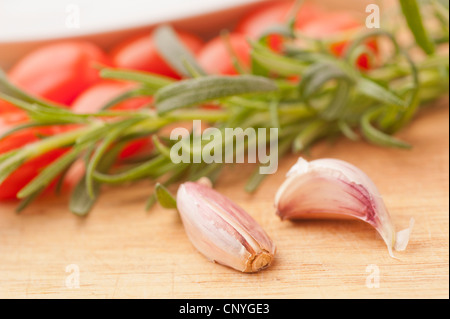 Two garlic cloves and rosemary Stock Photo