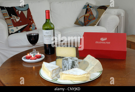 A selection of west country cheeses from the west of England UK in a comfortable living room Stock Photo