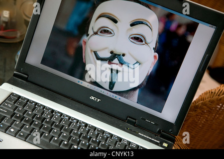 "Anonymous" masked face on computer screen, London Stock Photo