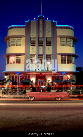 1930's Art Deco architecture  at night depicting neon lights and passing cars, Miami Beach, USA.