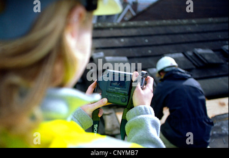 Site engineer recording site progress with a digital camera. Stock Photo