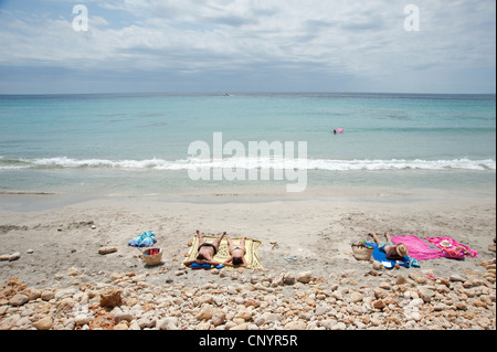 Sunbathers on Binigaus beach Menorca Spain Stock Photo