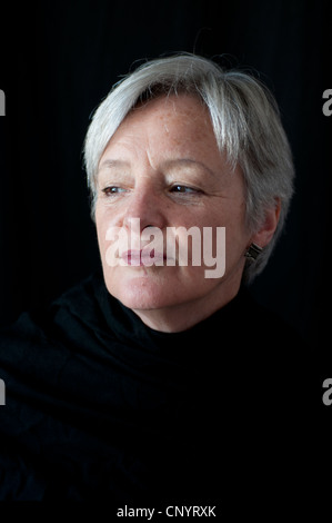 Portrait of middle aged woman against black background Stock Photo