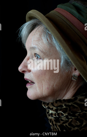 Middle aged woman with safari hat and leopard scarf looking shocked Stock Photo