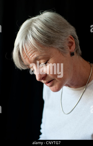 Middle aged woman looking down wistfully Stock Photo