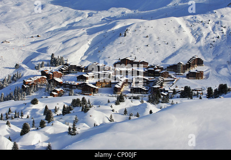 snowbound ski resort in the sunshine seen from a mountain slope, France, Savoie, Belle Plagne Stock Photo
