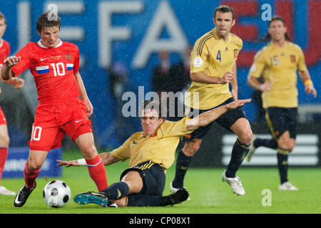 Carles Puyol of Spain (R) tackles Andrei Arshavin of Russia (L) during a UEFA Euro 2008 semifinal match on June 26, 2008. Stock Photo