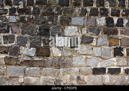 Old styled wall made from different stone blocks Stock Photo
