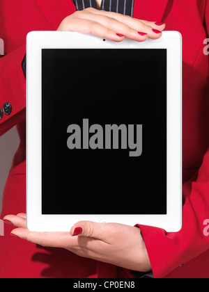 Closeup of a woman in red business suit holding an iPad with blank screen in her hands Stock Photo