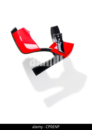 Trendy red with black high heel platform shoe falling through the air isolated on white background Stock Photo