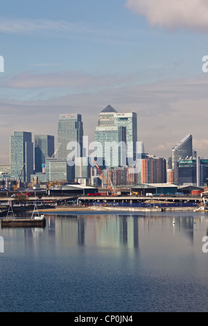 View west towards Canary Wharf financial district in London from Royal Victoria Dock, London, Eng;land, UK Stock Photo