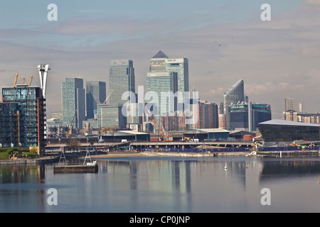 View west towards Canary Wharf financial district in London from Royal Victoria Dock, London, Eng;land, UK Stock Photo