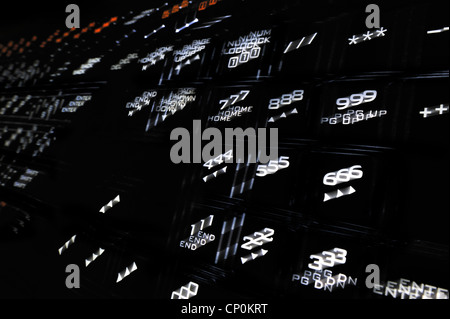 Abstract technology image showing black computer keyboard with illuminated backlit white characters on keys jumping out Stock Photo