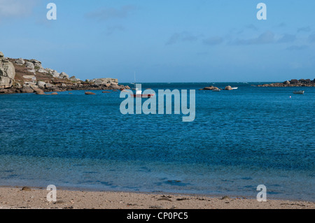 View of Porth Hellick beach on St Mary's on the Isles of Scilly with a boat moored in the bay Stock Photo