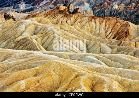 The sun baked badlands and many hues of Golden Canyon in California’s Death Valley National Park. Stock Photo