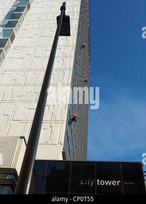 Three window cleaners outside City Tower in Manchester UK Stock Photo