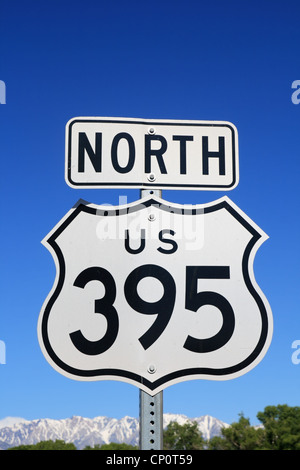 north US 395 sign with blue sky and mountains in the background Stock Photo