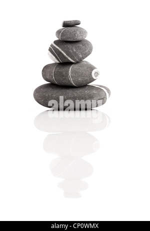 Stones pyramid isolated on white background with reflection Stock Photo