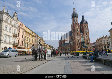 Carriages waiting for tourists in Krakow's Main Market Square, Krakow, Poland. Stock Photo