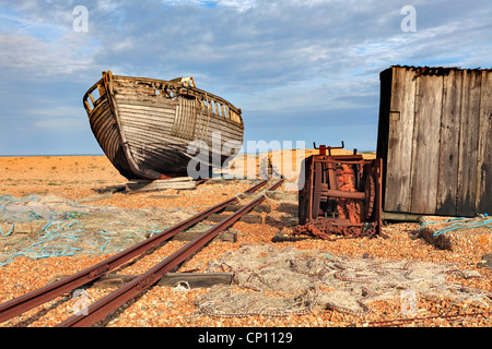 An abandoned boat next to an old rail track at Dungeness in west Kent Stock Photo