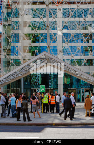 Staff assemble at fire safety point outside, 55 Baker Street, Marylebone, London, UK, Europe Stock Photo