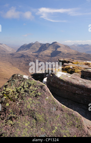 Lichen covered sandstone rocks on the summit of Tom na Gruagaich, Beinn Alligin, with Liathach in the background, Torridon Stock Photo