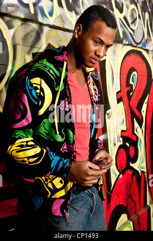 Young man waiting and thinking leaning on a wall Stock Photo