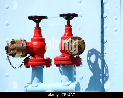 red industrial faucet wheel on blue background, nobody Stock Photo