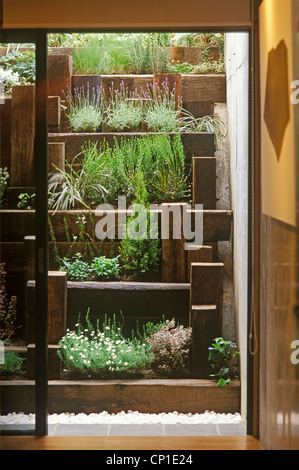 View through sliding door to terraced garden beyond Stock Photo