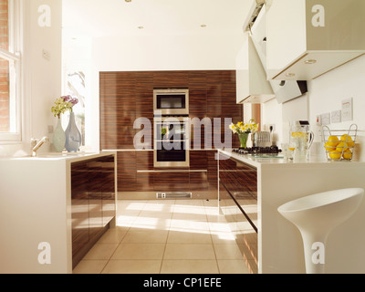 Integral oven set in wooden unit in spacious contemporary kitchen Stock Photo