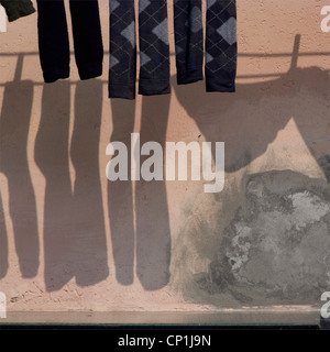 Socks hanging on Venice building exterior. Stock Photo