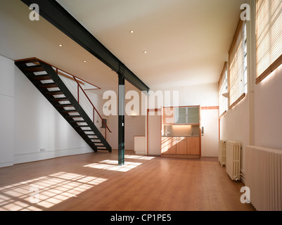 Empty office space with exposed steel beams and staircase Stock Photo