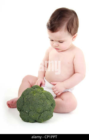 Baby looking at broccoli Stock Photo