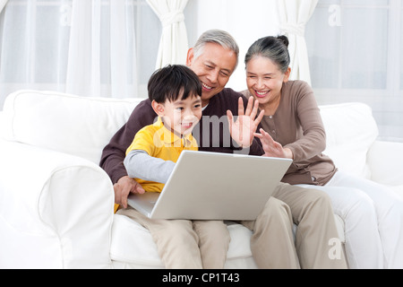 Grandparents and grandson using laptop Stock Photo