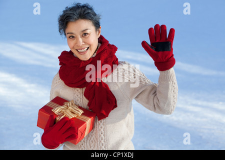Senior woman holding gift boxes Stock Photo