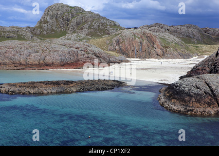 Couple on the beautiful sandy beach of Port Ban on the west coast of Iona taken from Eilean Didil Stock Photo