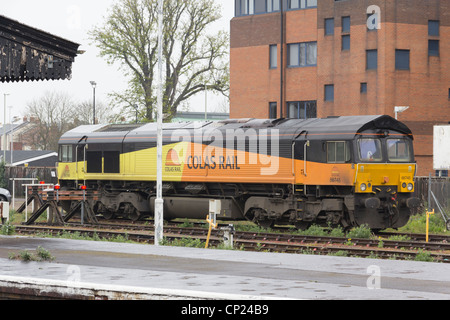 A class 66 diesel electric locomotive in the livery of Colas Rail, stabled in sidings near Gloucester railway station. Stock Photo