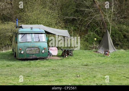 Old Bedford camper van and tent on a campsite in the Manifold Valley, Derbyshire, England, UK Stock Photo