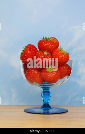 Strawberries in a sundae glass against a blue sky Stock Photo