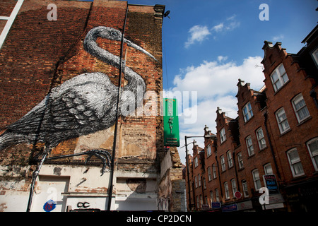 Street Art in East London. Roa is a Belgian street artist renowned for his giant black and white animals. Crane on Hanbury St. Stock Photo