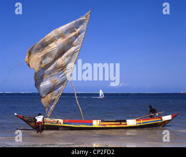 Colourful dug-out fishing boat with sail, North Coast, Mombasa, Mombasa County, Republic of Kenya Stock Photo