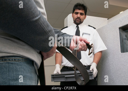 Suspect being searched at charge desk in a police station Stock Photo