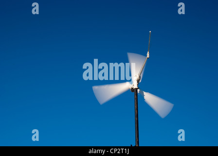 Wind turbine against a bright blue sky with clouds Stock Photo - Alamy