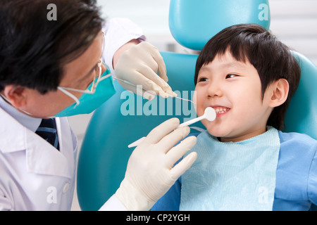 Little patient receiving treatment in dental clinic Stock Photo