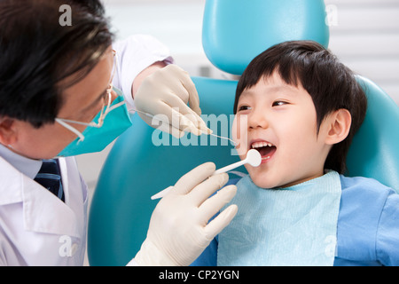 Little patient receiving treatment in dental clinic Stock Photo