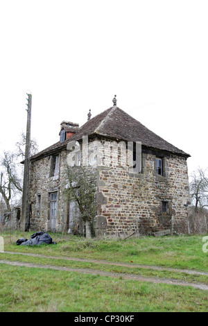 It's a photo of an old house in stone in Normandy in countryside of France. It almost collapses. It is abandoned and broken. Stock Photo