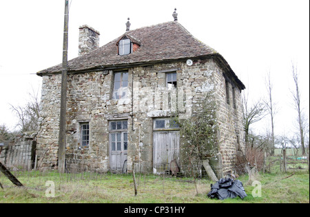 It's a photo of an old house in stone in Normandy in countryside of France. It almost collapses. There is no habitant in it. Stock Photo