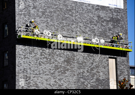 Workmen using a cradle at the Premier Inn, Manchester. Stock Photo