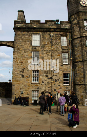 Tourists in front of the royal palace inside the Edinburgh Castle with clocktower and inside the Crown Square Stock Photo
